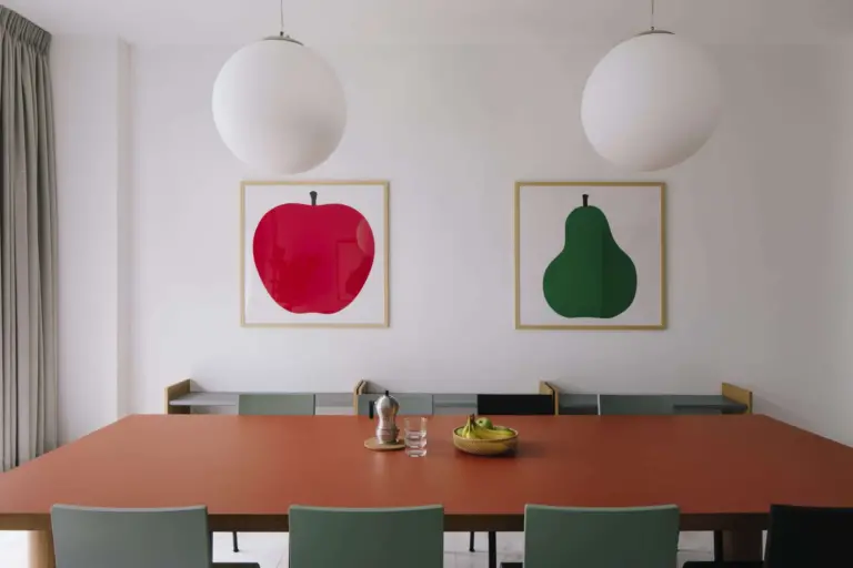 A long dining table prepared for a small house conversation